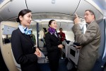 ANA flight attendants Maki Sakatani, left, and Kyoko Kouokawa, right, talk with 787 program VP Scott Francher on board.