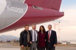University of Montana and Horizon Air execs take a photo op under the tail