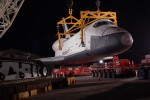 Space Shuttle Enterprise is lowered onto a custom trailer. (Photo by Guy Dickinson, CC BY-SA)