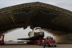 The space shuttle Enterprise, mounted on transport vehicle, is backed into a temporary hanger after being demated from the NASA 747 Shuttle Carrier Aircraft (SCA) at John F. Kennedy (JFK) International Airport on Sunday, May 13, 2012. (Photo by NASA/Kim Shiflet)