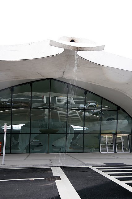 The very nature of the building evokes the natural organic beauty of mother nature's creatures of flight, particularly a butterfly raising its wings to fly.  The design even allowed the building to channel rain water from the roof into a gentle waterfall welcoming travelers as they began their journey.