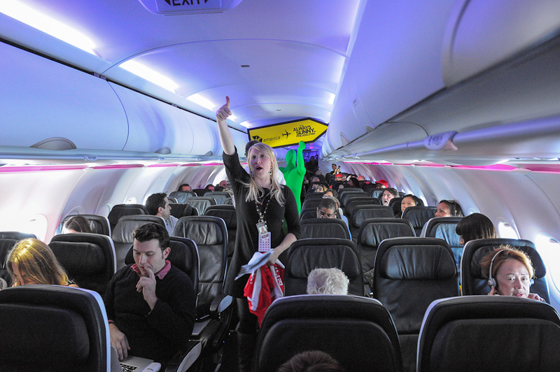 Virgin Ameica's passengers aboard the inaugural Flight 10 from Los Angeles to Philadelphia were treated to games and prizes. The Green Man handed out the loot and entertained everyone on board. (Photo by Manny Gonzalez/NYCAviation)