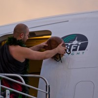A native Hawaiian christens the plane with a coconut. (Photo by Lyle Jansma)