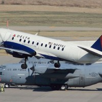 Some US Air Force C-17s watch a Delta Connection Saab 340A (N449XJ) take off from Minneapolis