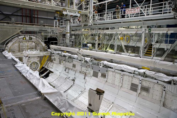 The payload bay of Discovery showing the missing Canadarm from its port side resting position. The object on the starboard side is the attachment to the Canadarm that increases its reach under the orbiter for scanning of the thermal protection system. (Photo by Suresh A. Atapattu/WWW.ATAPATTU.NET)