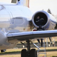 A technician examines the left engine of an Allegiant Air MD-83 at Paine Field, Wash., after it made an emergency landing.