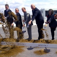 Delta executives, New York Mayor Mike Bloomberg and other local politicians take part in the ceremonial first dig for the 630-foot long bridge that will connect Terminals C and D.
