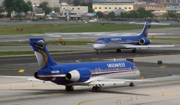 Two Midwest Airlines Boeing 717s, N902ME and sister ship N904ME, taxiing to their gates at LaGuardia Airport. (Photo by Ron Peel)