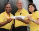 Scoot executives pose with a model Boeing 777 with a full-size version in the background. (Photo by Scoot)
