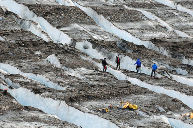 Military personnel examine a debris field on Knik Glacier, about 40 miles northeast of Anchorage, Alaska. (Photo by US Army)
