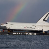 Enterprise meets a rainbow in New York Harbor. (Photo by Wavefront)