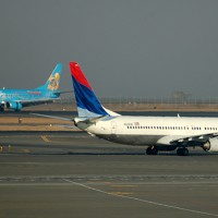 Alaska's Disneyland Boeing 737-400 crosses paths with a Delta 737-800 in Seattle. (Photo by Andrew W. Sieber via Flickr, CC-BY-NC)