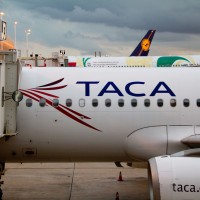 TACA Airbus parked at a gate. (Photo by Frederick Durand via wikimedia, CC-BY-SA)