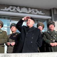 Kim Jong-un watches something in the sky. (Photo by Korean Central News Agency)