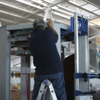 A technician assembles a brand new TSA body scanner. (Photo by Matt Molnar/NYCAviation)