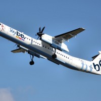 A Flybe Bombardier Dash-8-400 (G-JECL) takes off from Manchester Airport, England. (Photo by Arpingstone via wikimedia)
