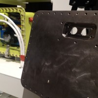 The new 787 battery enclosure adds another layer of protection and eliminates the potential for fire. At right is cover for the enclosure, which is made of 1/8-inch stainless steel. (Photo courtesy  © Boeing)