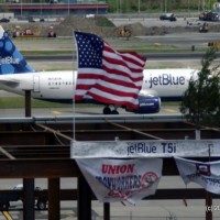 The final I-beam used in constructing the new T5i on display, with a JetBlue A320 in the background