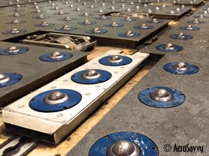 Main deck floor rollers and pallet locks. “It's all ball bearings nowadays!” (Photo by the author)