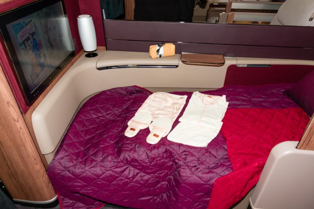 A first class seat that has been transformed into a bed. 