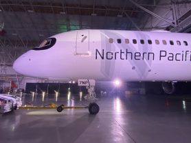 The forward end of the 757 features "Northern Pacific" titles superimposed over a greyscale "N". A "raccoon mask" of black paint surrounds the flight deck windows.