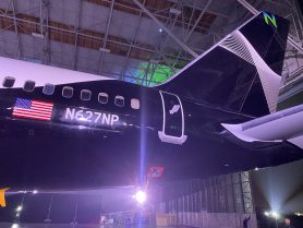 The tail of the aircraft, showing the N627UP registration alongside the US flag. The tail includes white artwork and a green and blue 'N' on a black background.