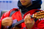 Keda Lee strums his ukulele providing a hint of what awaits in Hawaii for the guests of Alaska Airlines inaugural Bellingham to Honolulu Flight.