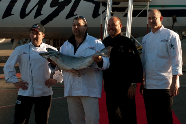 Chefs pose with the salmon. (Photo by Tad Carlson)