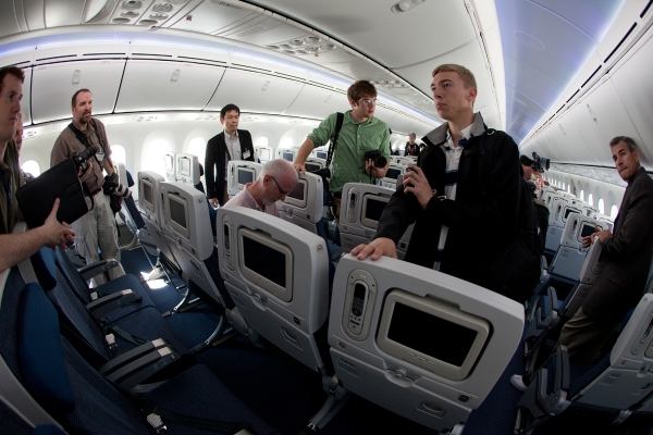 Reporters quiz Boeing staff in the economy section. Reporters quiz Boeing staff in the economy section.