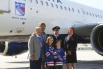Rod Gilbert, Ron Duguay pose with the flight's captain and head flight attendant. (Photo by Matt Molnar/NYCAviation)