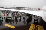 Crowds take refuge from the rain under the wing. (Photo by Jeremy Dwyer-Lindgren)