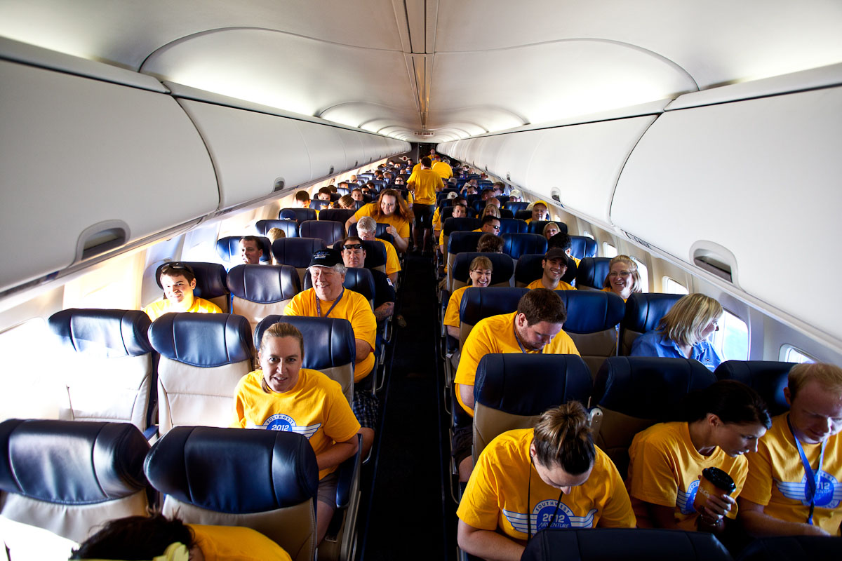 Southwest employees, family members, and media guests seat themselves prior to the flight.