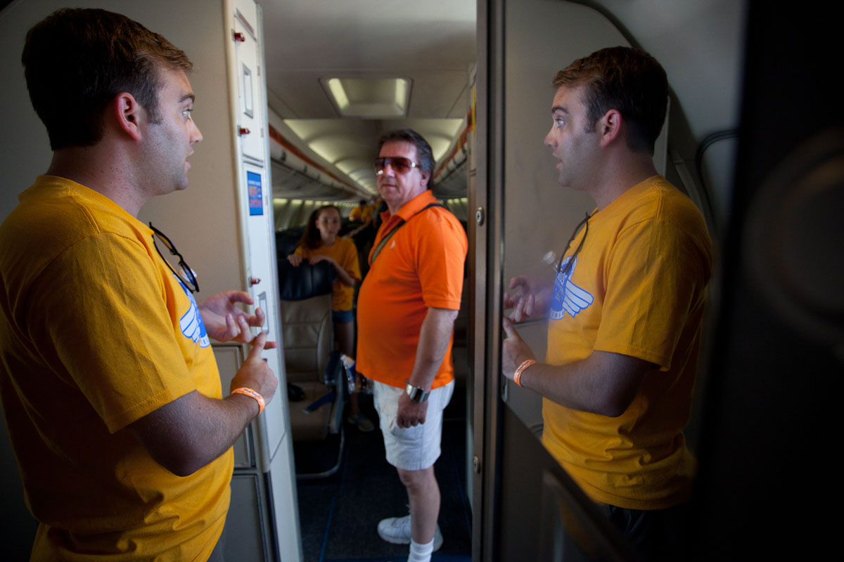 Brooks Thomas, communications employee with Southwest Airlines, welcomes a visitor on board the newly revamped 737-700.