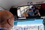 A volunteer bus driver checks up on departing passengers while making a stop on the AirVenture bus route.