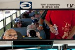 A volunteer bus driver checks up on departing passengers while making a stop on the AirVenture bus route.
