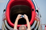 A visitor snaps a picture into the intake of the venerable F-86 intake.