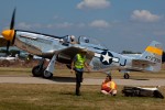 The Brat III taxies back to th warbird ramp as a volunteer tends to a ramper who took a spill off her scooter.