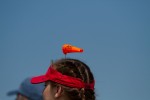 An AirVenture 2012 windsock graces the cap of an attendee.