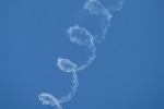 A skydiver lights up the sky with a corkscrew.