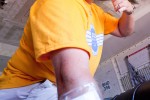 An employee climbs into the cargo hold and begins unloading boxes at OSH.