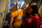 Inflight Supervisor Jenny McCormick greets another employee as folks board the ferry flight to Oshkosh