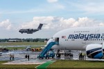 Airbus A400M Atlas landing behind the Malaysia Airlines A380. (Photo by Airbus)