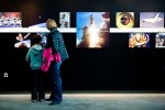 Nicholas (10) and Sarah Chesemore of Bellevue Washington look at pictures of a wall depicting history of the shuttle program. (Photo by Jeremy Dwyer-Lindgren/NYCAviation)