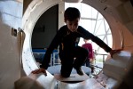 Nicholas Chesmore, 10, from Bellevue Washington climb into the crew compartment of the space shuttle trainer. (Photo by Jeremy Dwyer-Lindgren/NYCAviation)