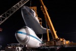 With Enterprise held by two cranes, the Shuttle Carrier Aircraft is pushed back. (Photo by Guy Dickinson, CC BY-SA)