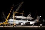 A set of cranes and wind restraints constructed to remove space shuttle Enterprise from atop NASA's 747 Shuttle Carrier Aircraft are being put into place. (Photo by NASA/Kim Shiflet)