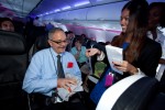 A 'Portlandia' contest winner is given his prize after correctly answering a prize during the onboard trivia game. (Photo by Jeremy Dwyer-Lindgren/NYCAviation)