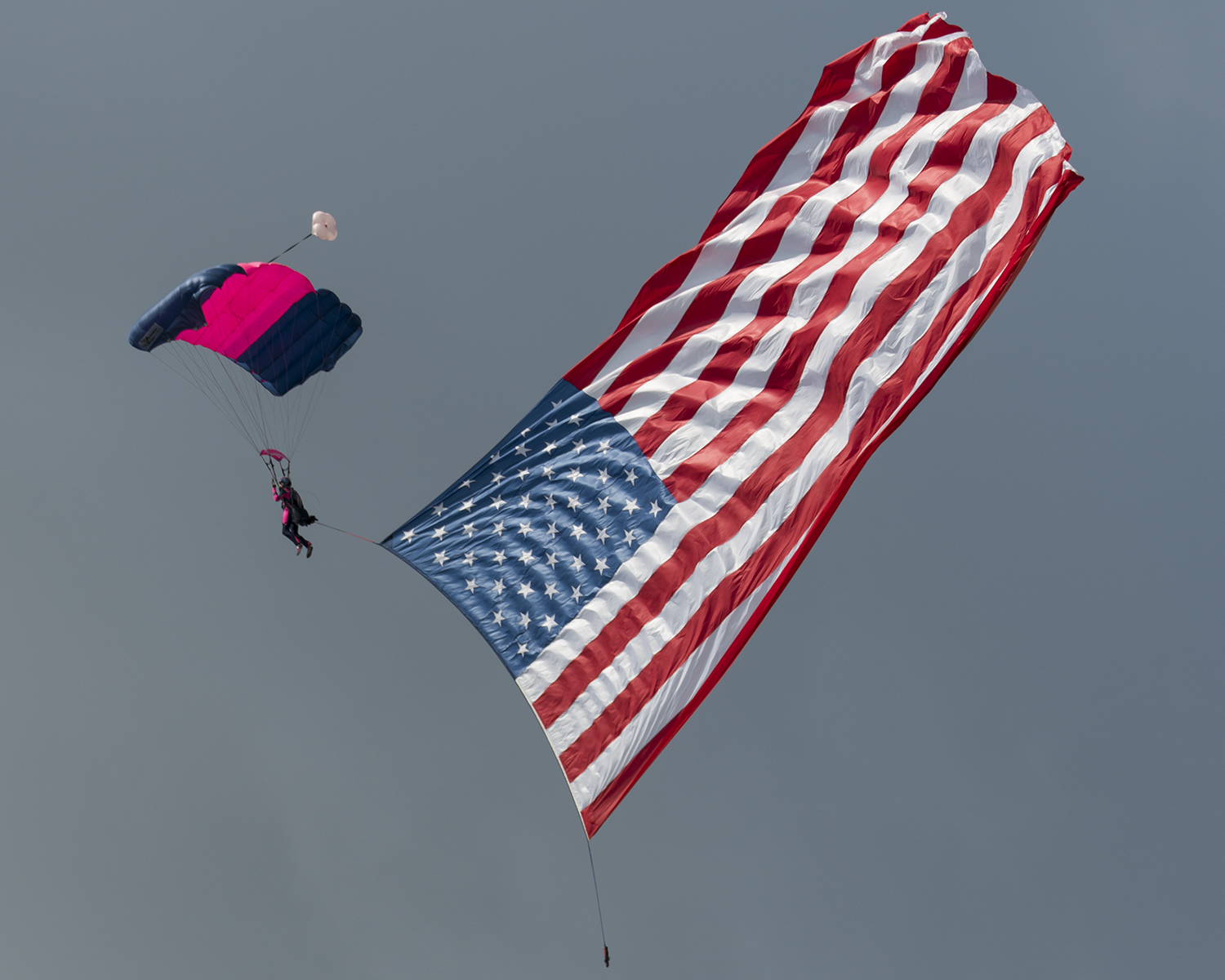 A member of the Misty Blues arrives at show center with the American Flag