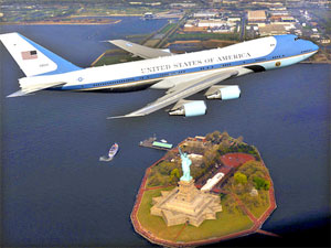 A VC-25 passes over the Statue of Liberty during a controversial photo shoot.