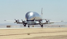 NASA's B377SGT Super Guppy Turbine cargo aircraft touches down at Edwards Air Force Base, Calif. on June 11, 2000 to deliver the latest version of the X-38 flight test vehicle to NASA's Dryden Flight Research Center. (Photo by NASA)